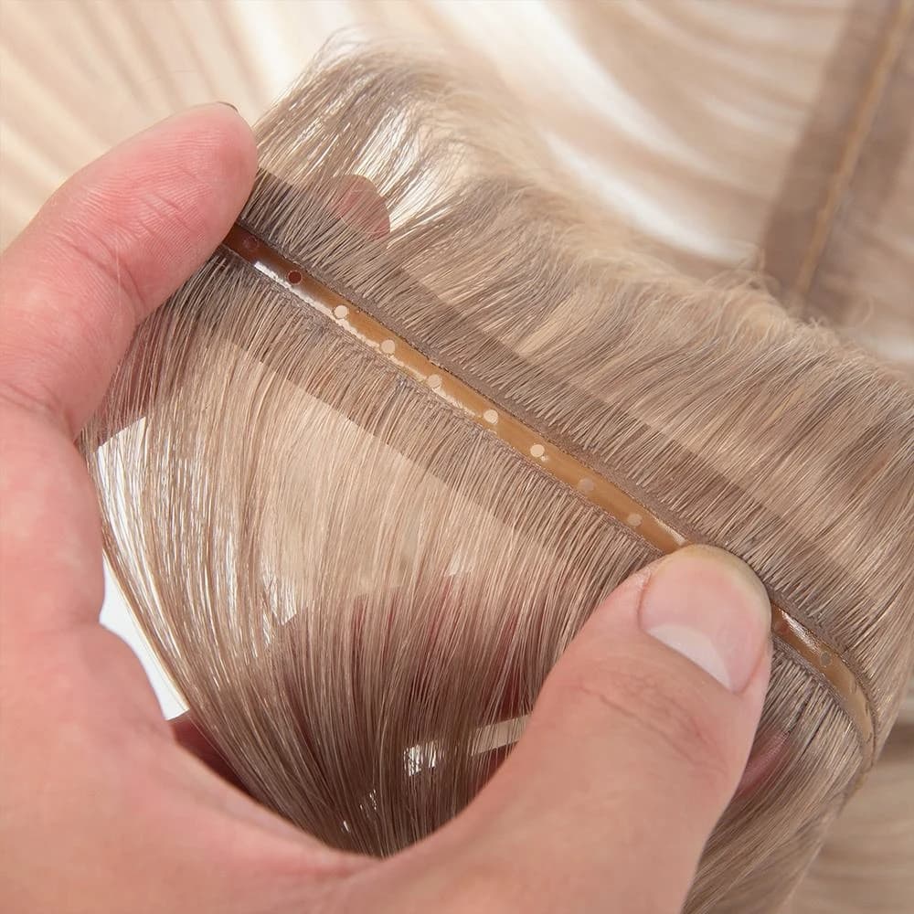 Light-colored Butterfly Weft band held open with round attachment holes visible