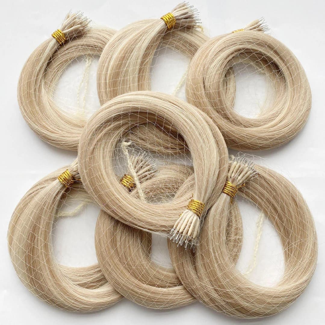 Coiled pale blonde nano extension bundles held in protective hair nets