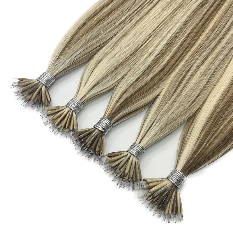 Five dimensional blonde nano extension bundles with their prepared tips arranged on white