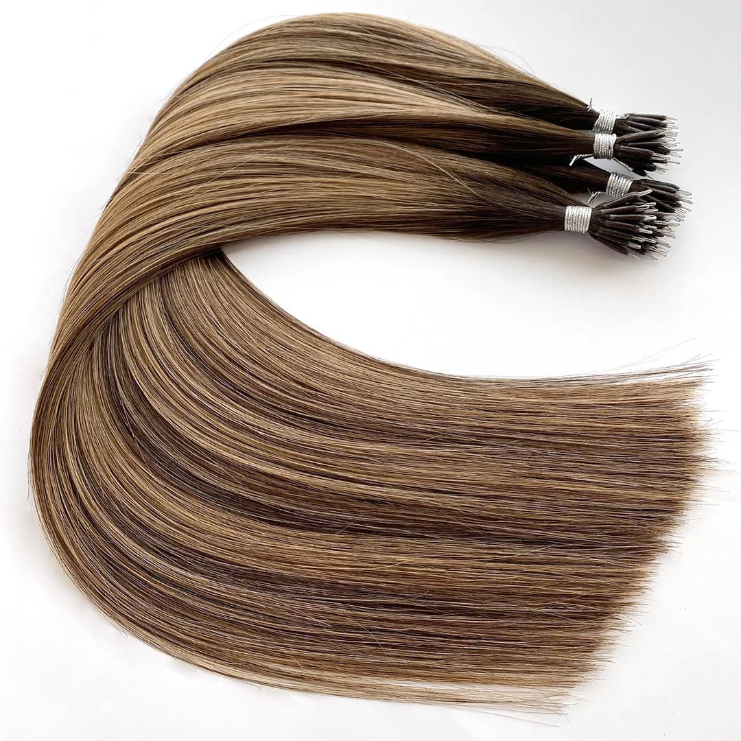 Rooted brown and blonde nano extension bundles arranged in a broad curve