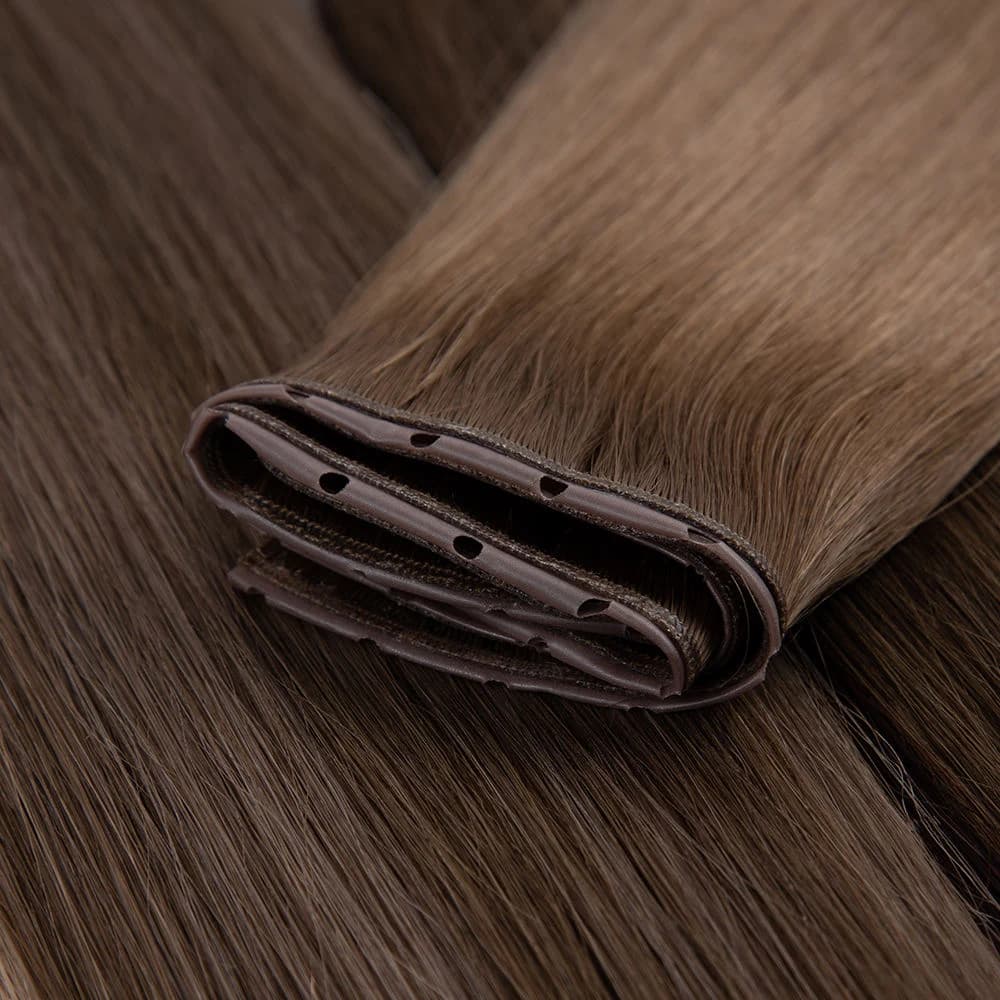 Folded brown Butterfly Weft showing layered bands and attachment holes