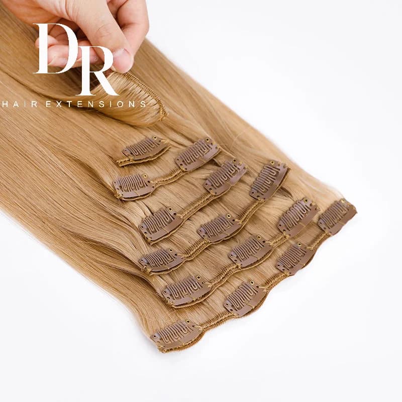 Blonde DR clip-in pieces with sewn edges and rows of metal clips visible