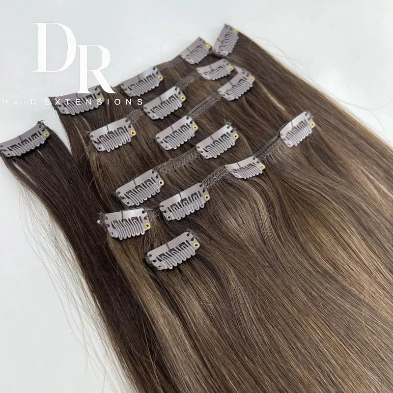 Brown DR clip-in hair extension pieces arranged with metal clips visible