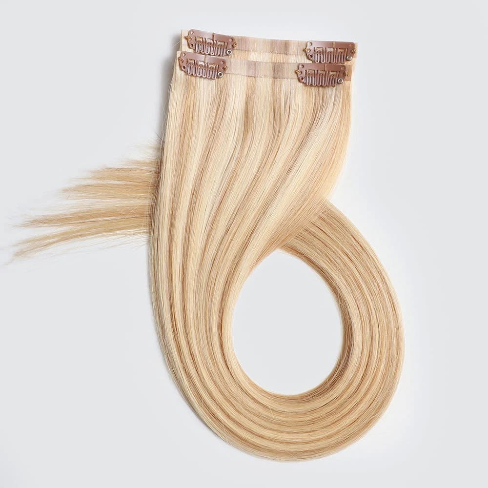 Blonde clip-in pieces curved into a loop with their upper bases and clips visible
