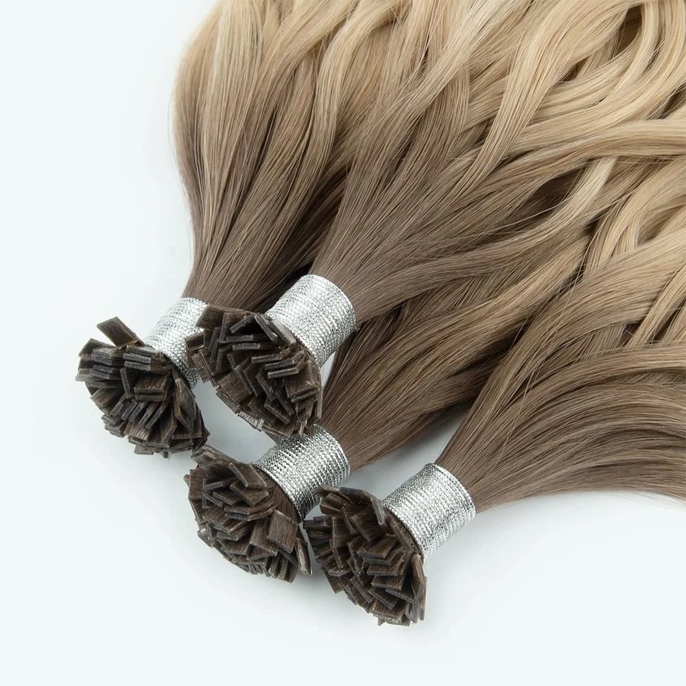 Close-up of rooted blonde individual-tip hair bundles and their attachment ends
