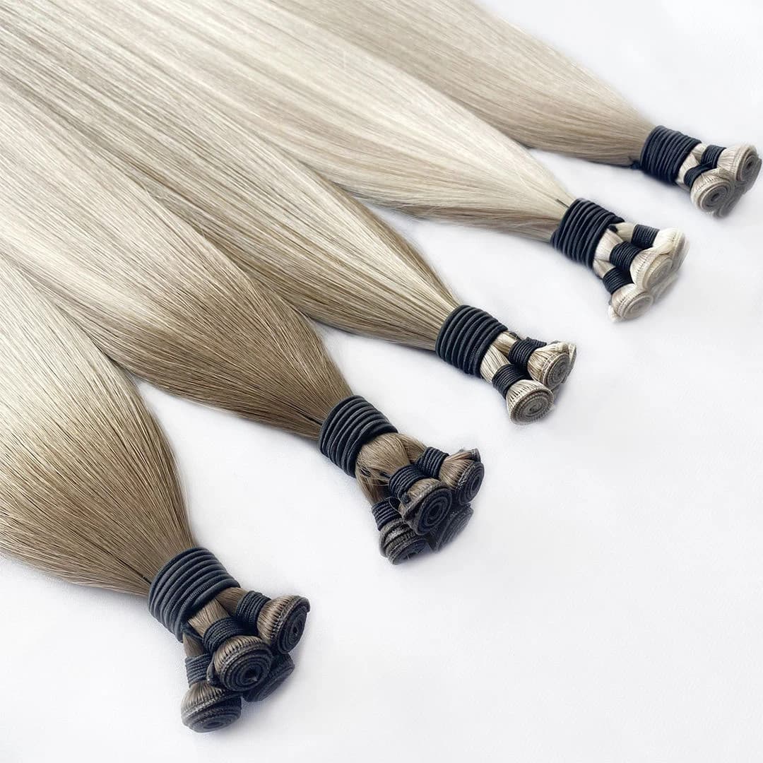 Cool blonde and ash-toned weft bundles with their rolled seams visible